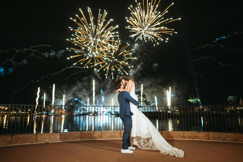 Bride and Groom kissing under fireworks at EPCOT after Disney Wedding