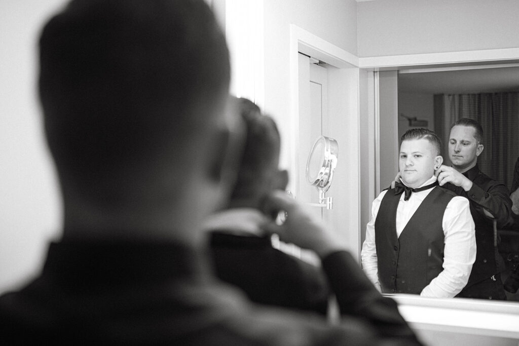 Groom looking in mirror